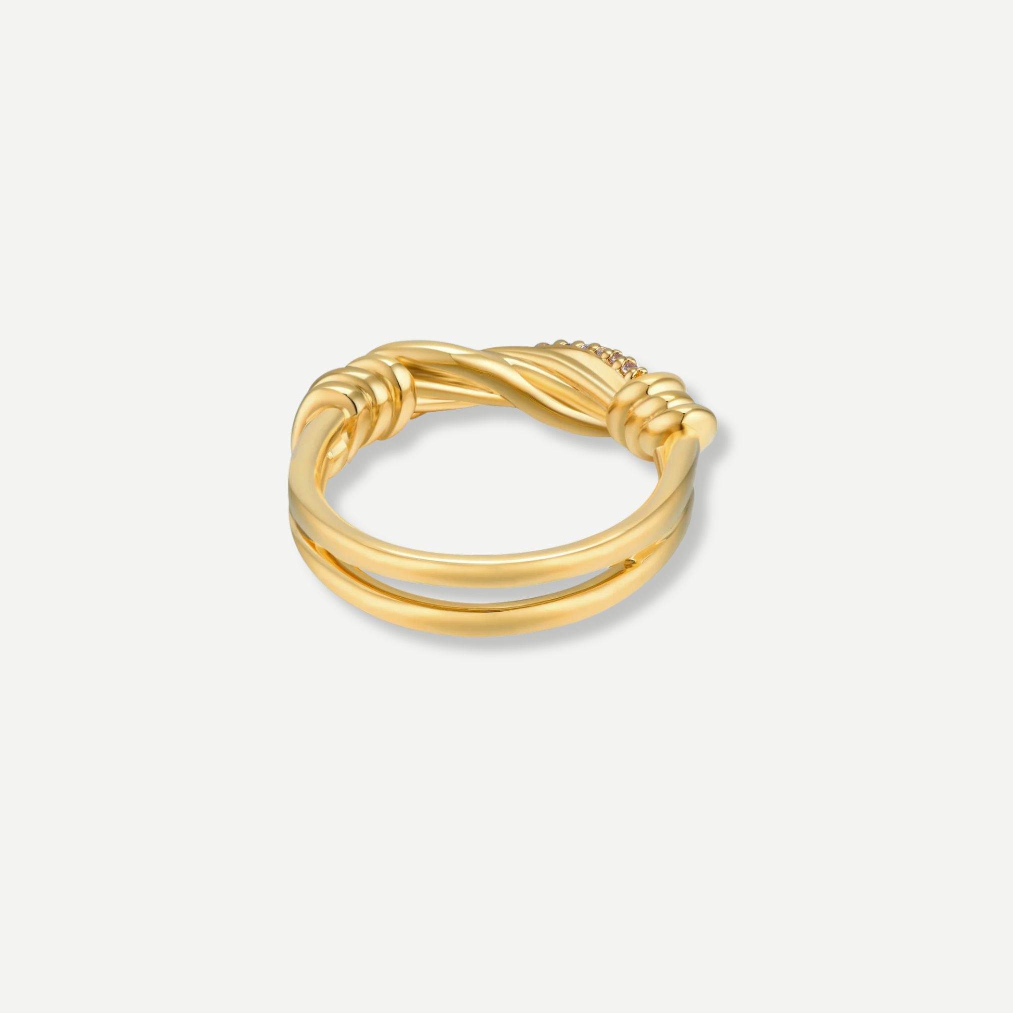 Gold ring with a twisted design on a light gray background