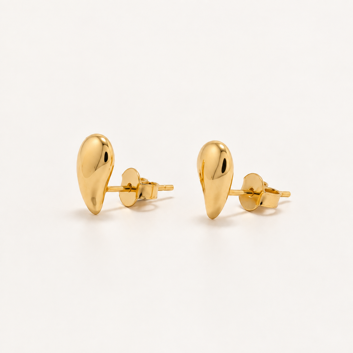 A pair of gold teardrop-shaped stud earrings with a polished finish, displayed on a clean white background.