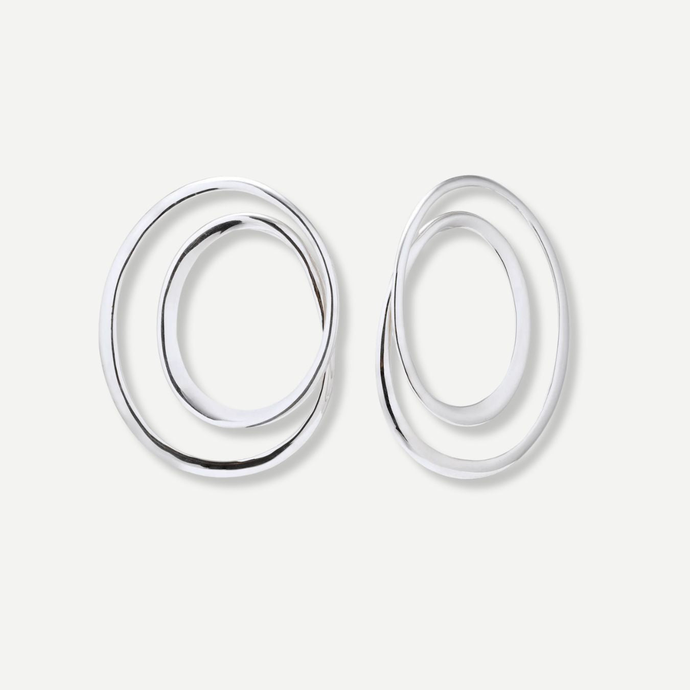 Pair of silver hoop earrings on a light gray background