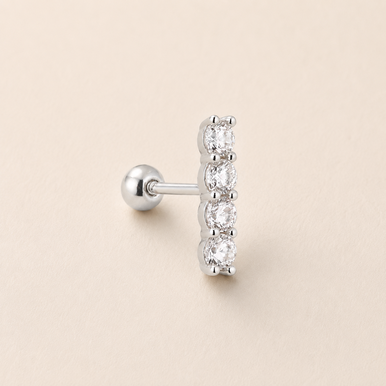 A single silver stud earring featuring a vertical bar of five clear round-cut gemstones, shown on a light beige textured background.