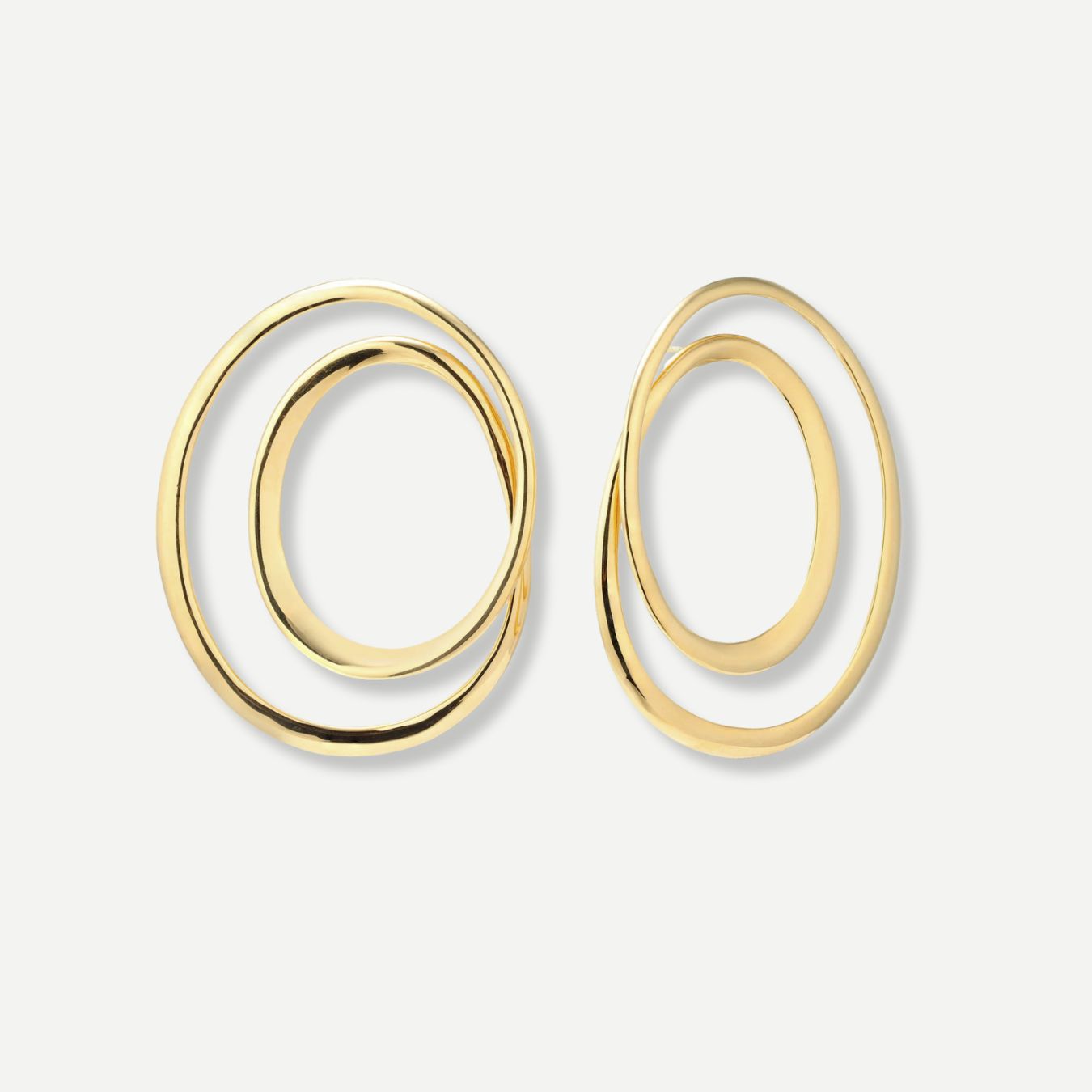 Gold hoop earrings on a light gray background